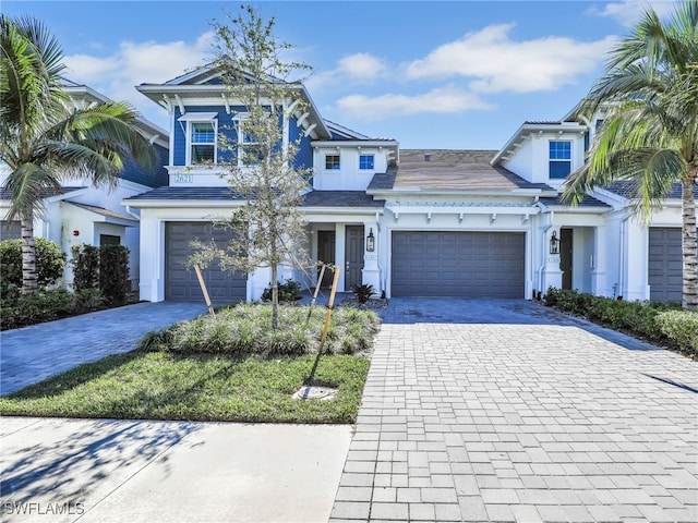 view of front facade featuring decorative driveway and stucco siding