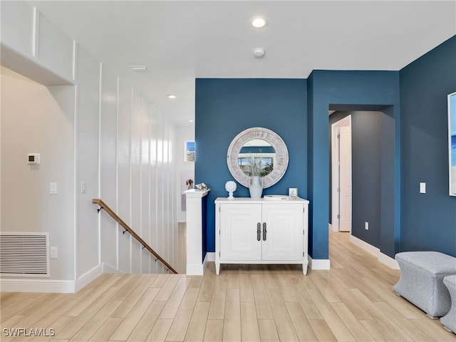 entryway with recessed lighting, wood finished floors, visible vents, and baseboards