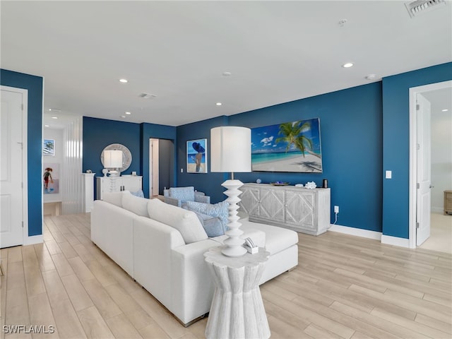 living area featuring light wood-style floors, recessed lighting, and visible vents