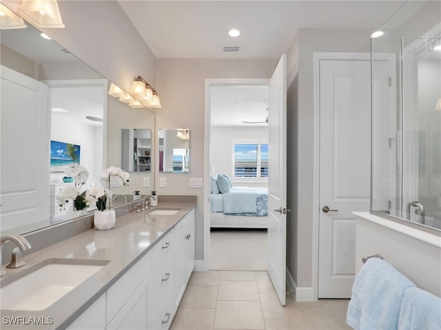 ensuite bathroom featuring ensuite bath, a sink, a shower with door, and tile patterned floors