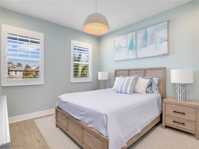 bedroom with wood finished floors and baseboards