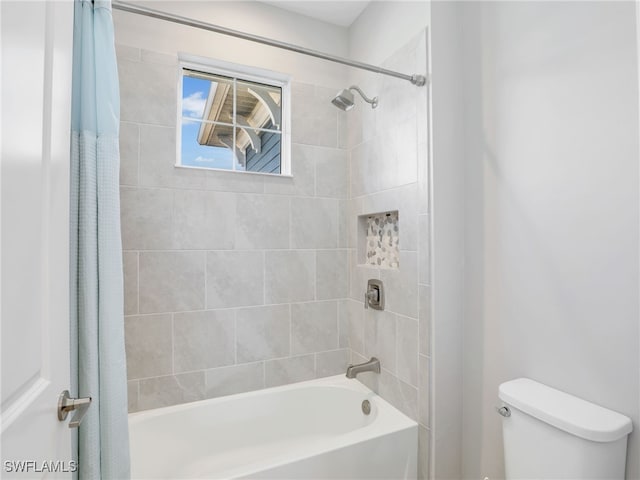 full bathroom featuring shower / bath combo and toilet