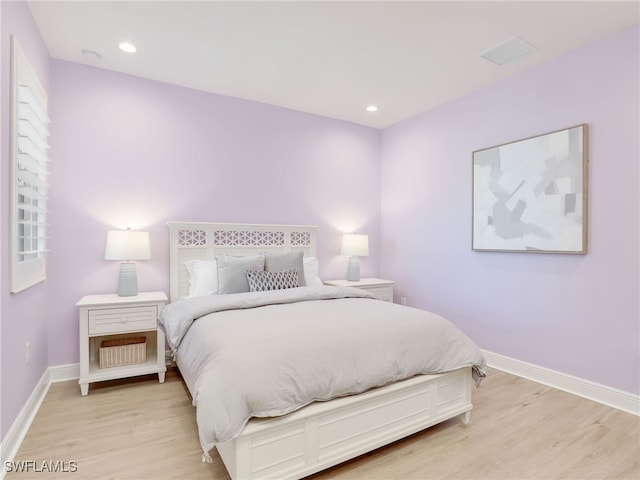 bedroom with recessed lighting, baseboards, visible vents, and light wood finished floors