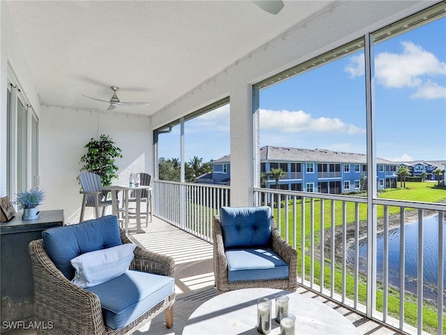 sunroom with a residential view and a ceiling fan