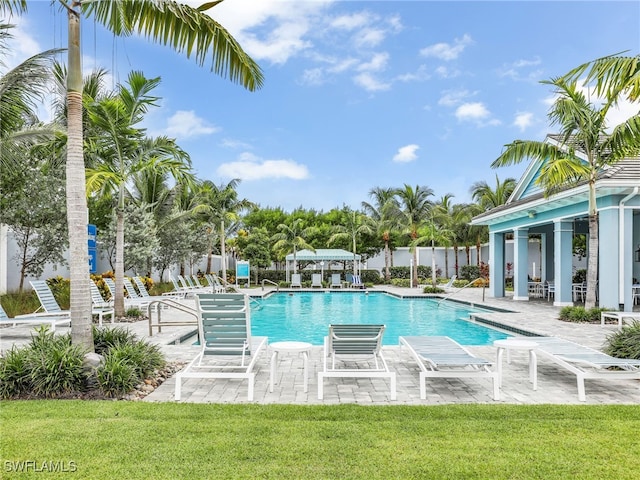 pool featuring a yard and a patio