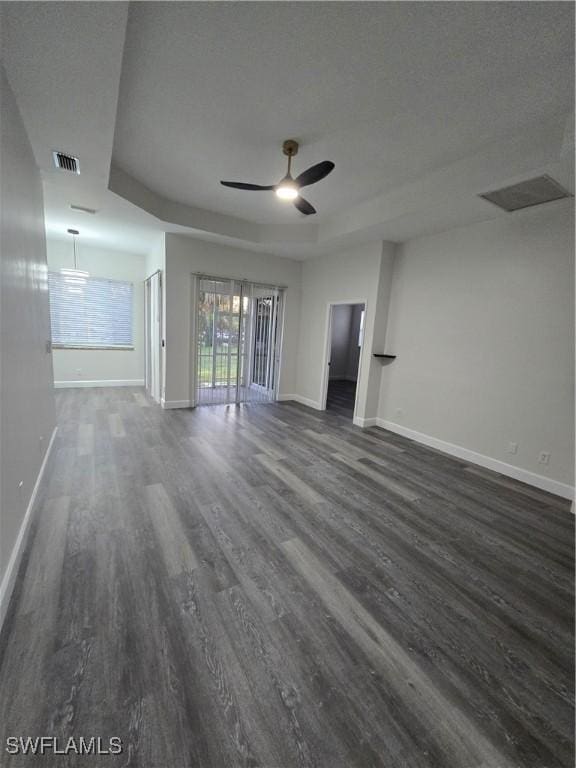 11285 La Coruna Ln, Bonita Springs, FL 34135 - unfurnished living room featuring visible vents, dark wood-style flooring, baseboards, and ceiling fan