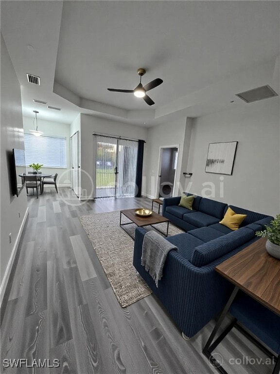 11285 La Coruna Ln, Bonita Springs, FL 34135 - living room featuring baseboards, visible vents, a ceiling fan, and wood finished floors
