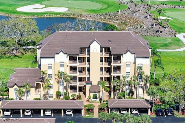 birds eye view of property with view of golf course and a water view