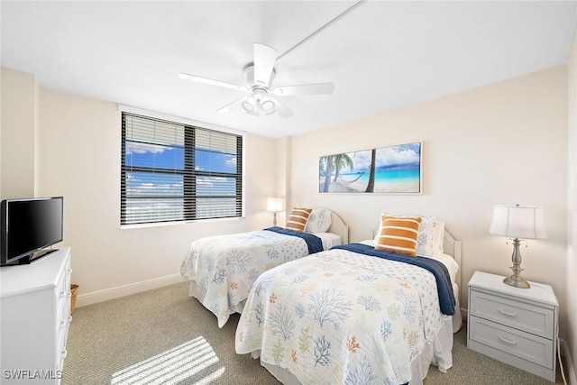 bedroom with a ceiling fan, baseboards, and carpet flooring