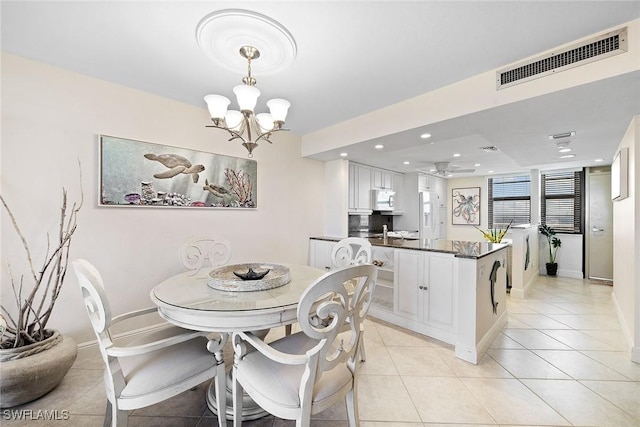 dining room featuring light tile patterned floors, recessed lighting, ceiling fan with notable chandelier, visible vents, and baseboards