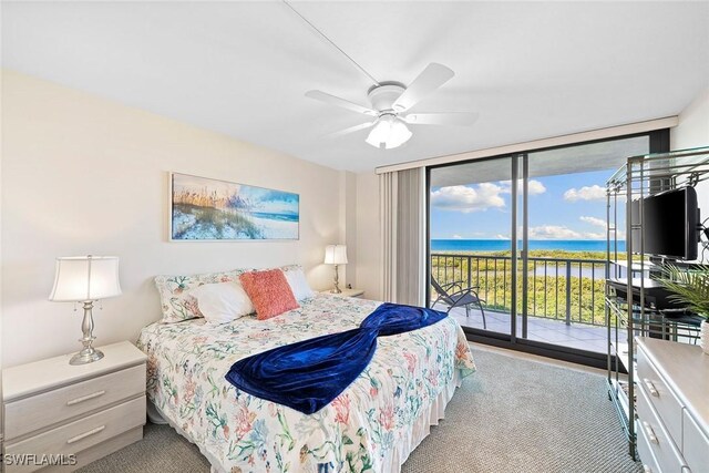 carpeted bedroom featuring access to exterior, floor to ceiling windows, and a ceiling fan