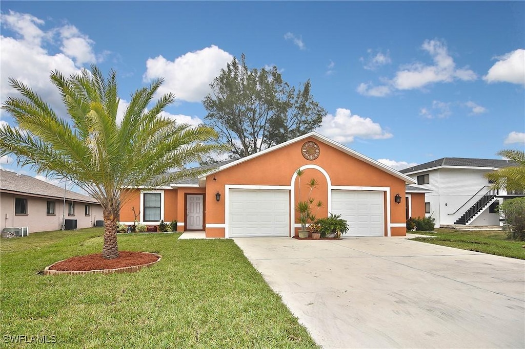 single story home featuring a garage, concrete driveway, a front lawn, central AC, and stucco siding