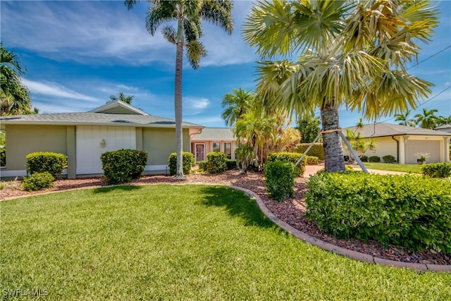 ranch-style home with stucco siding and a front yard