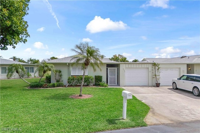 ranch-style home featuring an attached garage, stucco siding, concrete driveway, and a front yard