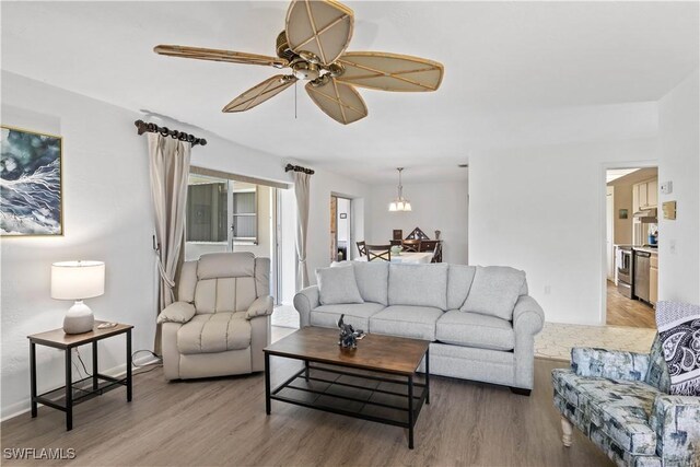 living area featuring a ceiling fan and wood finished floors