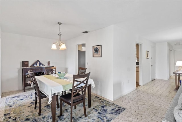 dining room featuring an inviting chandelier, baseboards, and visible vents