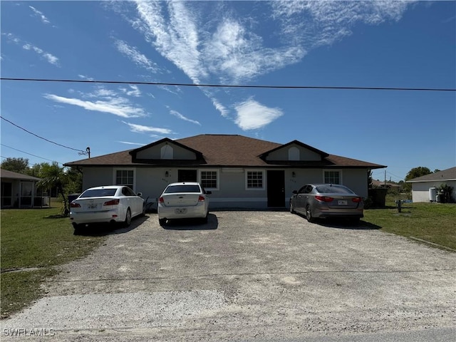 4517/4519 25th St, Lee, FL 33973 - ranch-style house featuring a shingled roof and a front lawn