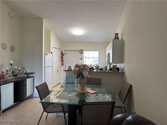 dining space featuring light tile patterned floors