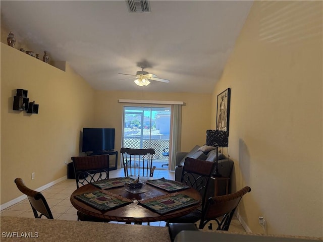 dining space featuring light tile patterned floors, visible vents, vaulted ceiling, and a ceiling fan