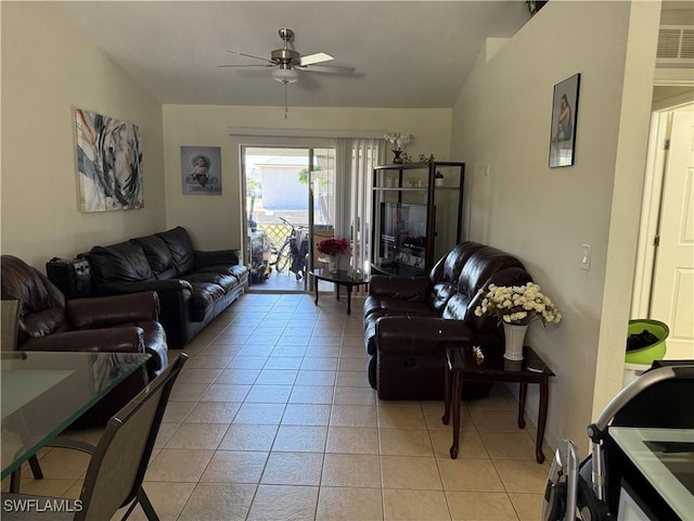 living area with light tile patterned floors, visible vents, vaulted ceiling, and a ceiling fan