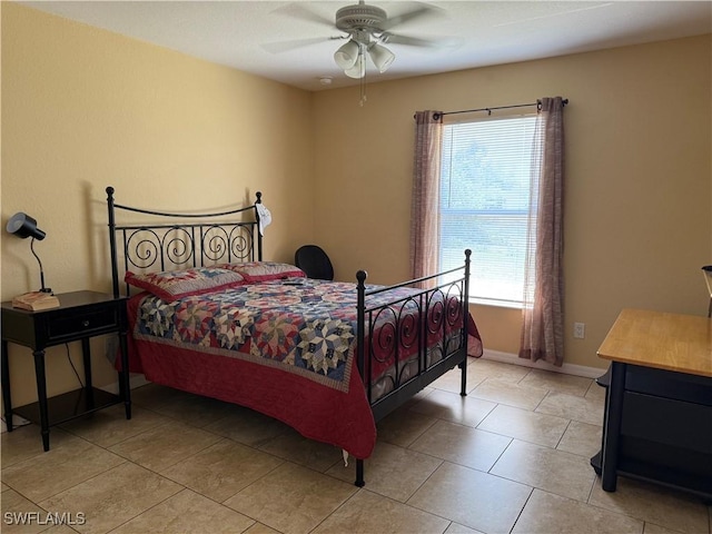 bedroom featuring tile patterned floors, a ceiling fan, and baseboards