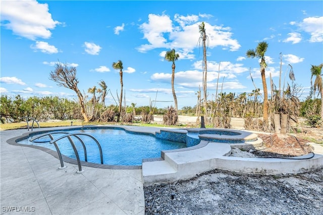 view of swimming pool with a patio and a pool with connected hot tub