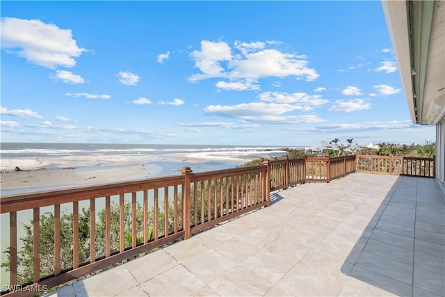 view of patio with a view of the beach and a water view