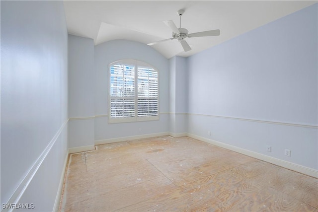 spare room with vaulted ceiling, baseboards, and ceiling fan