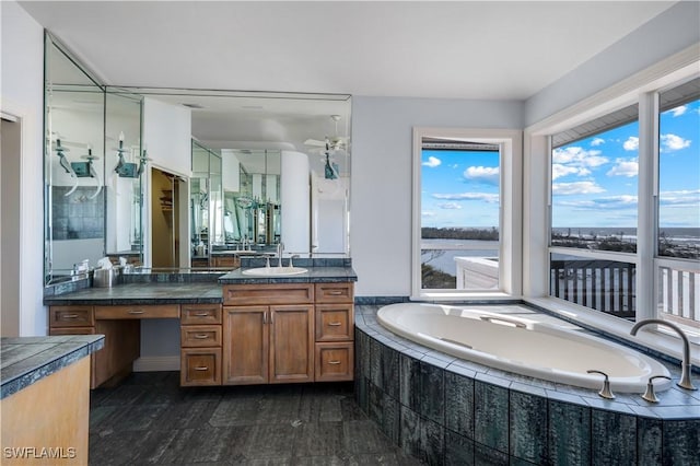 full bathroom with a garden tub and vanity