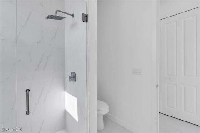 full bathroom featuring marble finish floor, a marble finish shower, toilet, and baseboards