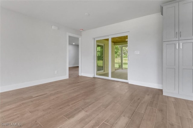 interior space with light wood-style flooring and baseboards