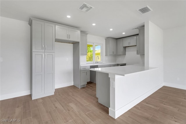 kitchen with light countertops, light wood-type flooring, visible vents, and recessed lighting