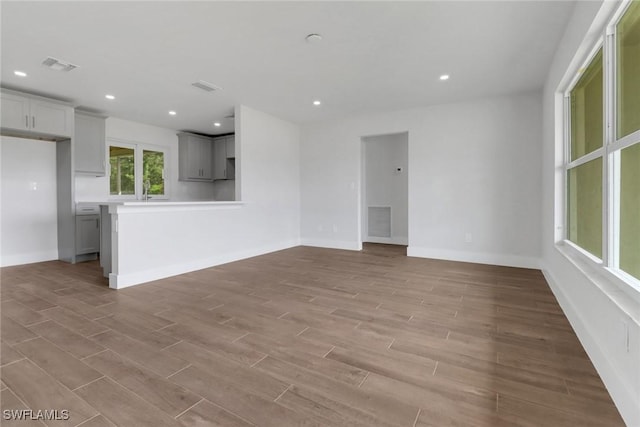 empty room featuring baseboards, recessed lighting, visible vents, and light wood-style floors