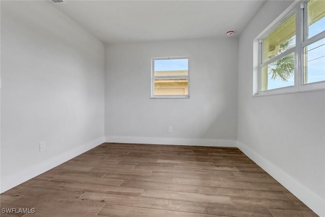 empty room featuring baseboards and wood finished floors