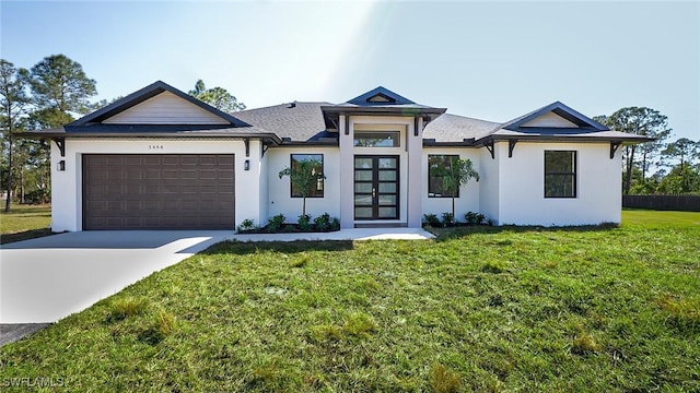 view of front of property with a front lawn, concrete driveway, a garage, and stucco siding