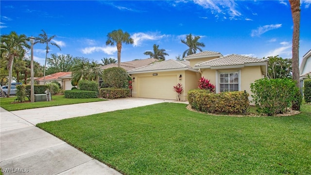 view of front of home featuring a garage, a tile roof, driveway, stucco siding, and a front yard