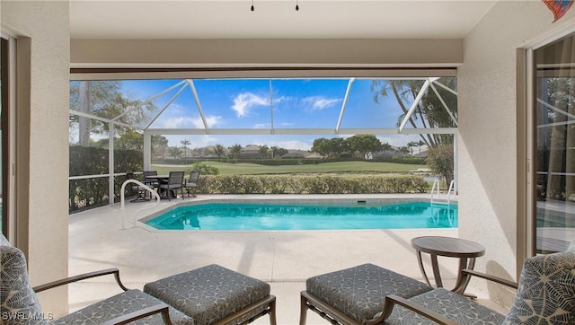 pool with a lanai and a patio