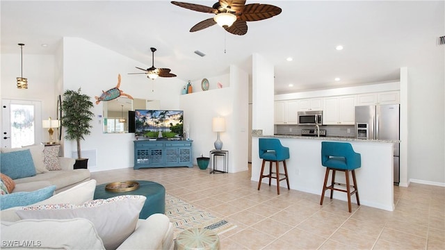 living room featuring light tile patterned floors, high vaulted ceiling, a ceiling fan, and recessed lighting