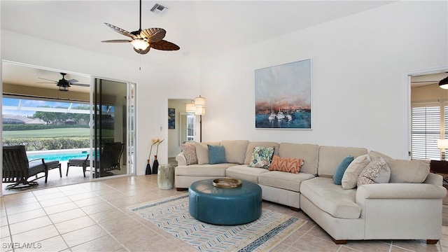 living area featuring tile patterned flooring, visible vents, and a ceiling fan