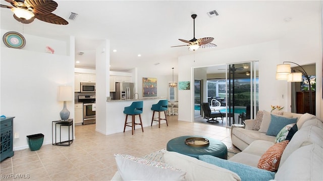 living room featuring visible vents, a ceiling fan, and light tile patterned flooring