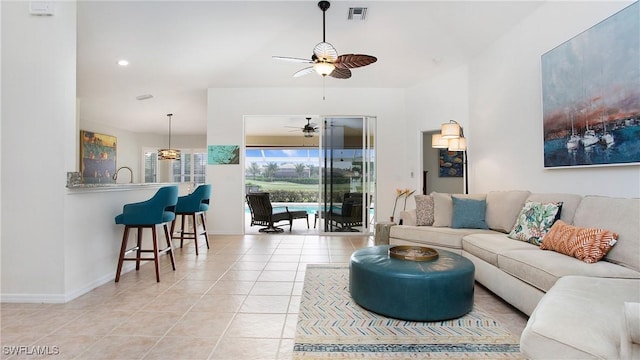 living room featuring baseboards, visible vents, ceiling fan, light tile patterned flooring, and recessed lighting