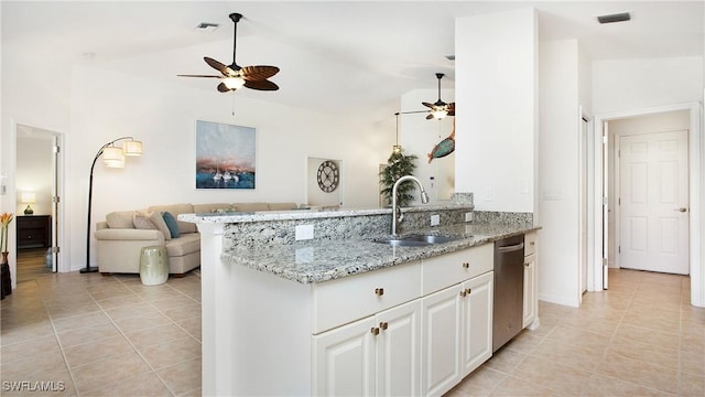 kitchen with light stone counters, visible vents, a ceiling fan, open floor plan, and a sink