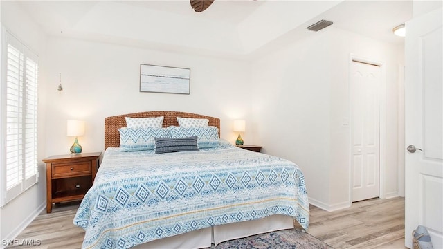 bedroom with baseboards, visible vents, and light wood-style floors