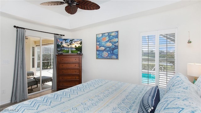 bedroom with access to exterior, a ceiling fan, and wood finished floors