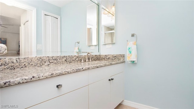 bathroom with vanity and baseboards