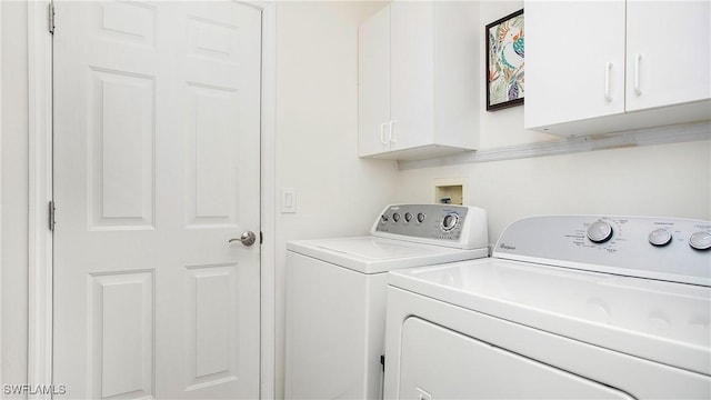 laundry room featuring washing machine and dryer and cabinet space