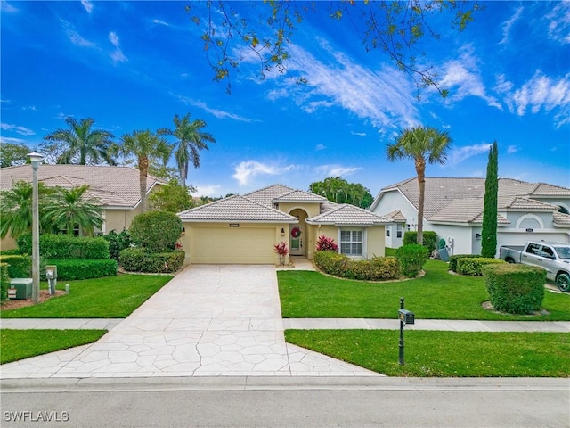 view of front of home with a tile roof, stucco siding, concrete driveway, a front yard, and a garage