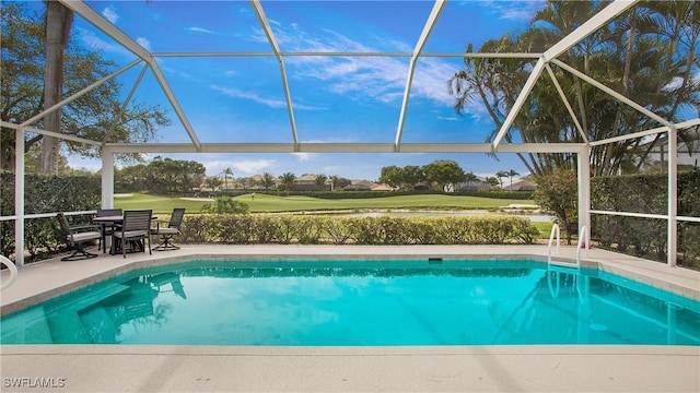 pool with a lanai, a patio area, and golf course view