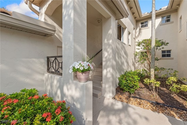 doorway to property with stucco siding