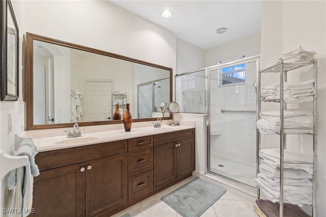 bathroom featuring a sink, a stall shower, and double vanity